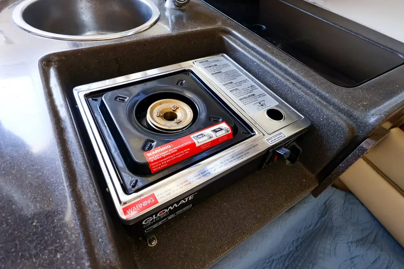 Slide: The Image of Grady-White Sailfish 282 (2015) boat kitchen with a compact stove and sink. - 36