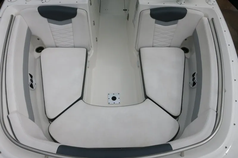 Slide: The Image of 2020 Robalo R247 Dual Console boat interior with white cushioned seating. - 23
