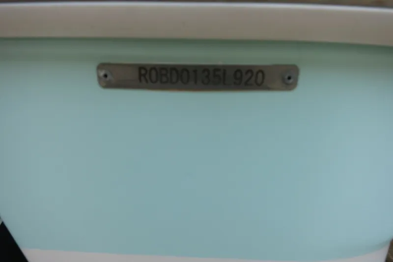 Slide: The Image of 2020 Robalo R247 Dual Console boat identification plate on light blue hull. - 33