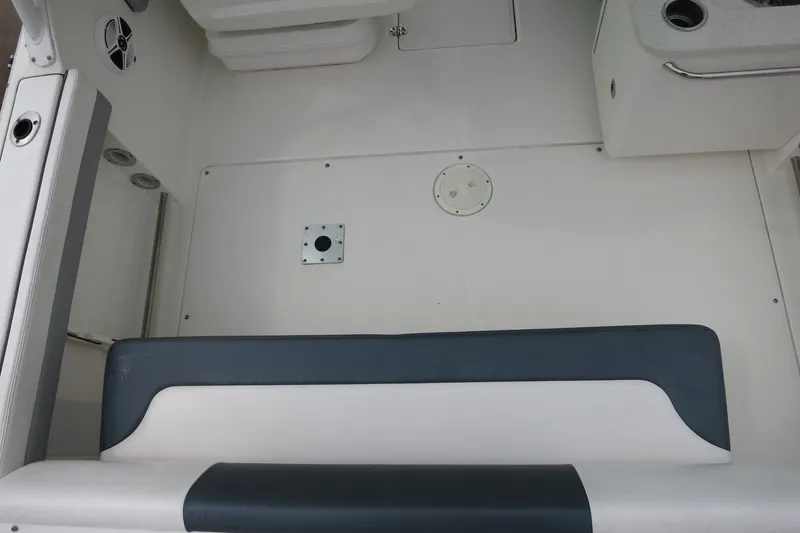 Slide: The Image of 2020 Robalo R247 Dual Console boat interior with seating and storage compartments. - 15