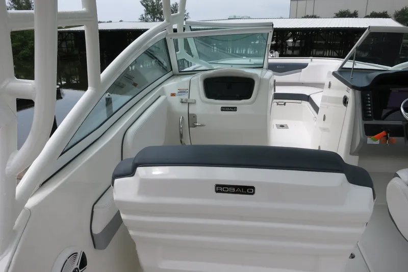 Slide: The Image of 2020 Robalo R247 Dual Console boat interior with seating and dashboard view. - 12