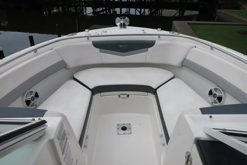 Slide: The Image of 2020 Robalo R247 Dual Console boat interior with cushioned seating and speakers. - 20