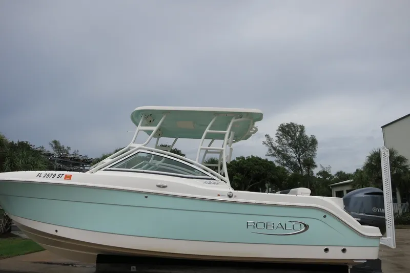 The Image of 2020 Robalo R247 Dual Console boat with sleek design, parked outdoors. - 0