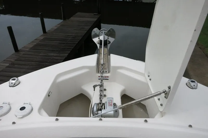 Slide: The Image of 2020 Robalo R247 Dual Console boat anchor system near dock. - 21