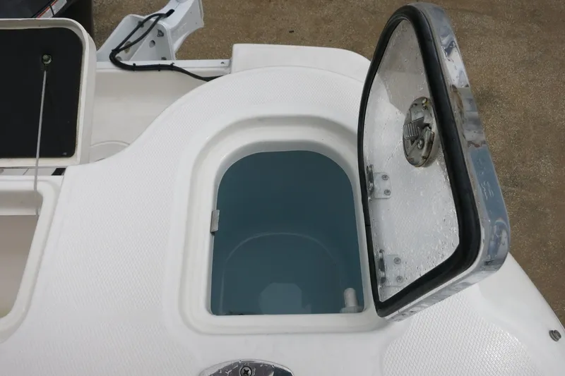 Slide: The Image of Open storage compartment on a 2020 Robalo R247 Dual Console boat. - 9