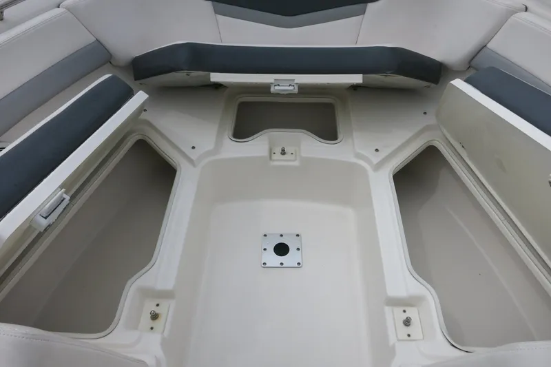 Slide: The Image of 2020 Robalo R247 Dual Console boat interior with open storage compartments. - 22
