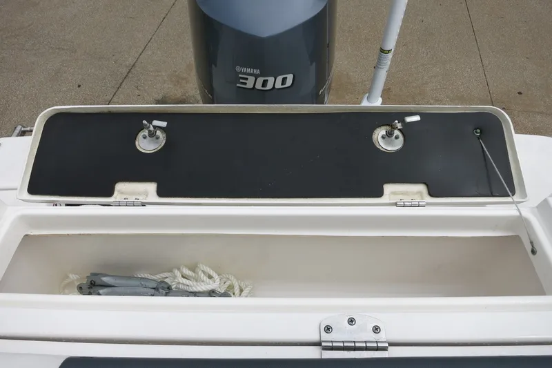 Slide: The Image of 2020 Robalo R247 Dual Console boat storage compartment with Yamaha 300 engine. - 8