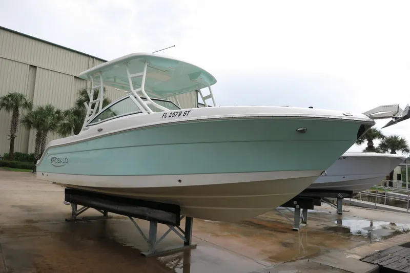 Slide: The Image of 2020 Robalo R247 Dual Console boat on display, featuring sleek design and light blue hull. - 3