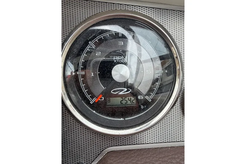Slide: The Image of Close-up of a 2016 Regal 2700 ES Bowrider tachometer displaying RPM and digital readout. - 32