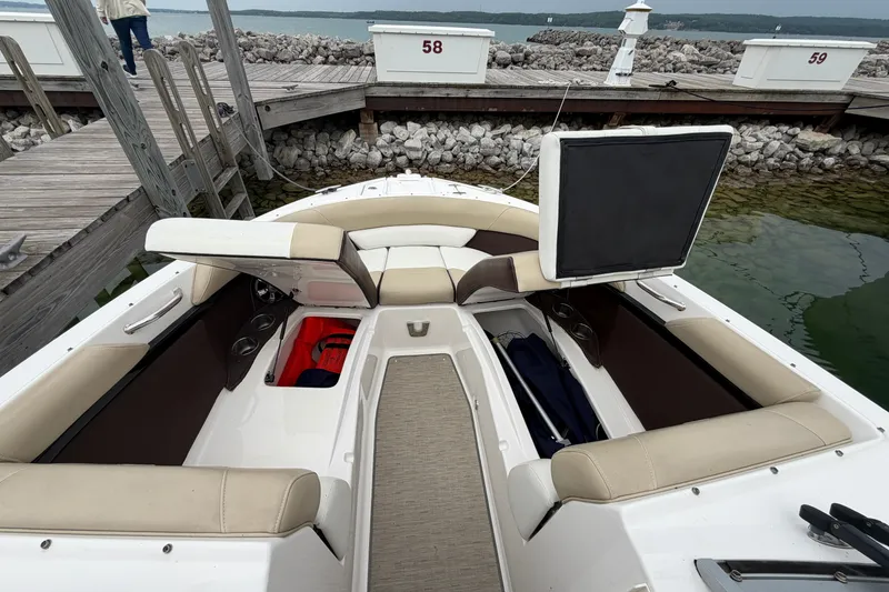 Slide: The Image of 2016 Regal 2700 ES Bowrider at dock, featuring spacious seating and storage compartments. - 25