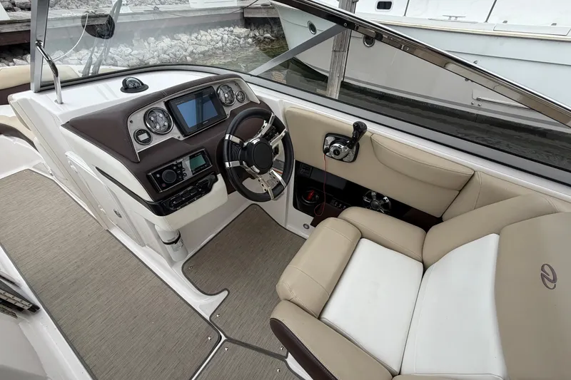 Slide: The Image of 2016 Regal 2700 ES Bowrider cockpit with steering wheel and control panel. - 16