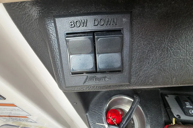 Slide: The Image of Control panel of a 2016 Regal 2700 ES Bowrider boat with "Bow Down" switches. - 18