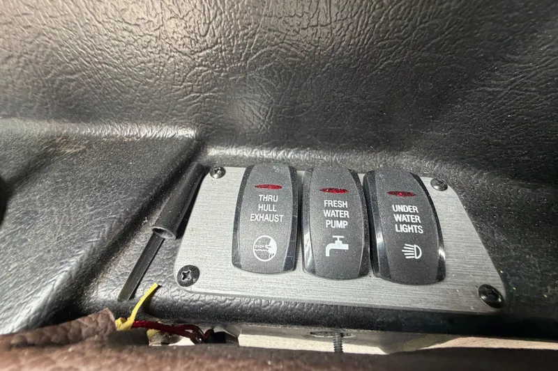 Slide: The Image of Control panel switches on a 2016 Regal 2700 ES Bowrider boat dashboard. - 19