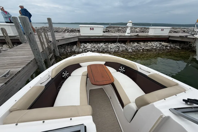 Slide: The Image of 2016 Regal 2700 ES Bowrider with seating and table, docked by a wooden pier. - 29
