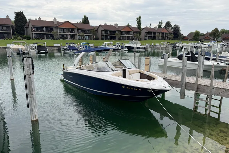 The Image of 2016 Regal 2700 ES Bowrider docked in a serene marina setting. - 1