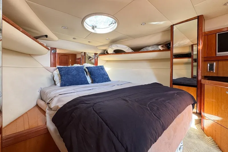 Slide: The Image of Luxurious cabin interior of 2004 Sunseeker Sportfisher 37 yacht with cozy bed and storage. - 96
