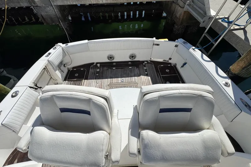 Slide: The Image of 2004 Sunseeker Sportfisher 37 boat interior with white seating and wooden deck. - 68