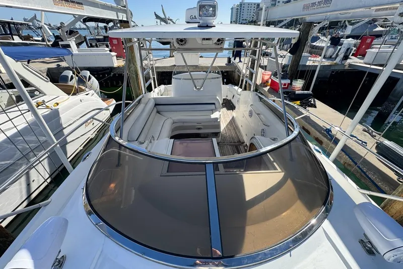 Slide: The Image of 2004 Sunseeker Sportfisher 37 yacht docked, showcasing spacious deck and seating area. - 65
