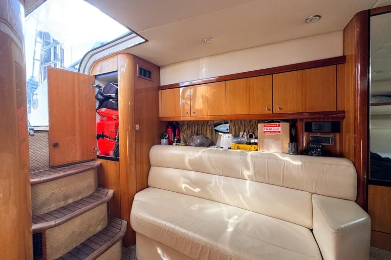 Slide: The Image of Interior of 2004 Sunseeker Sportfisher 37 with beige seating and wooden cabinetry. - 89