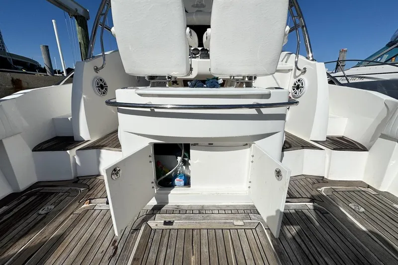 Slide: The Image of 2004 Sunseeker Sportfisher 37 boat interior with open storage compartment and wooden deck. - 17