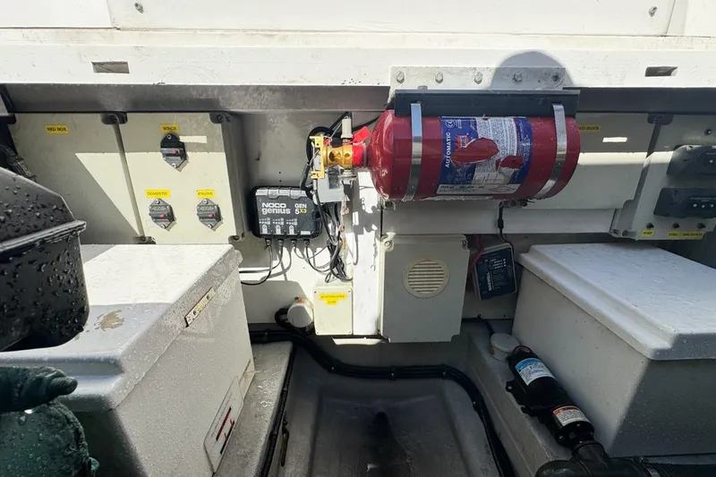 Slide: The Image of Engine compartment of a 2004 Sunseeker Sportfisher 37 with fire extinguisher and electrical components. - 127