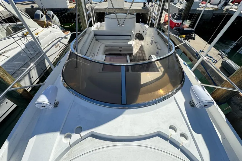 Slide: The Image of 2004 Sunseeker Sportfisher 37 boat deck with seating and railing, docked at marina. - 61