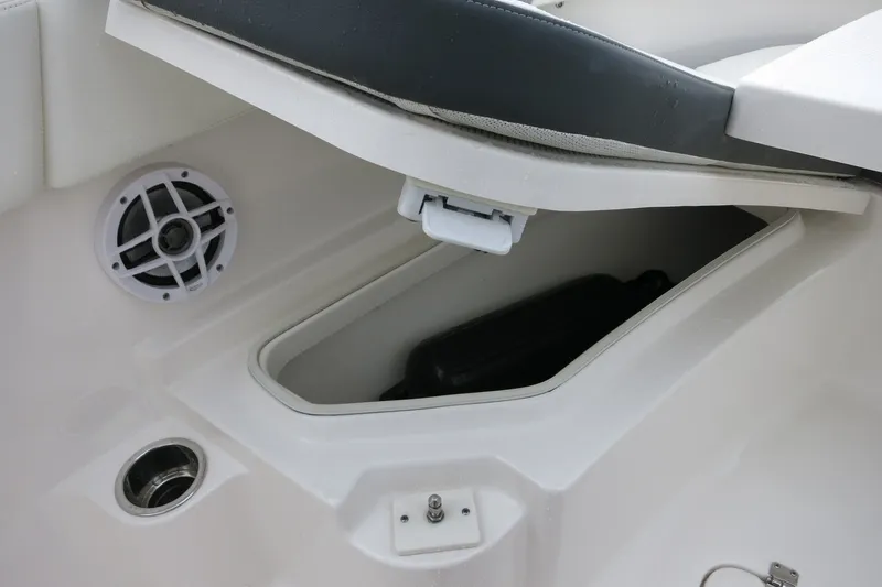 Slide: The Image of 2022 Robalo R230 Center Console boat storage compartment with speaker and seating. - 19