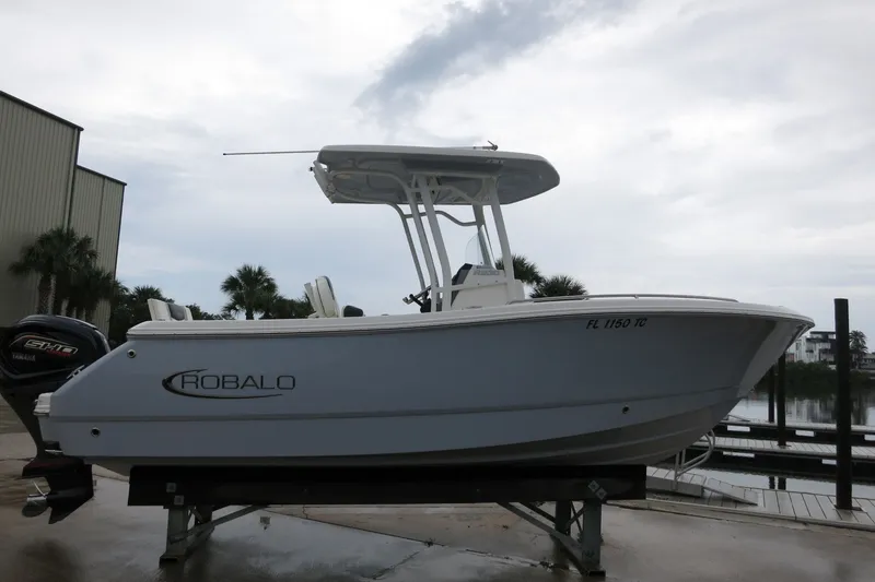 Slide: The Image of 2022 Robalo R230 Center Console boat on display at a marina. - 4