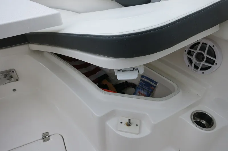 Slide: The Image of 2022 Robalo R230 Center Console boat storage compartment with speaker and cup holder. - 20
