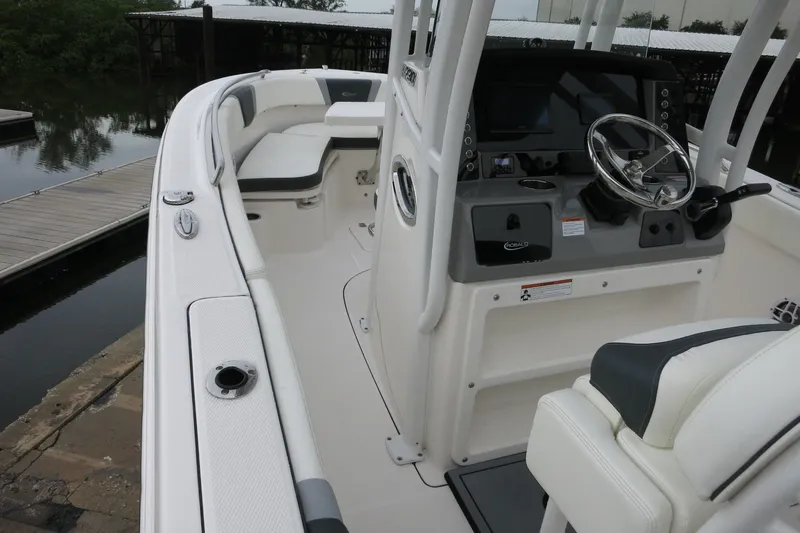 Slide: The Image of 2022 Robalo R230 Center Console boat interior with steering wheel and seating. - 13