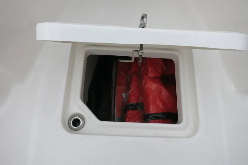 Slide: The Image of Storage compartment on 2022 Robalo R230 Center Console boat with life jackets inside. - 22