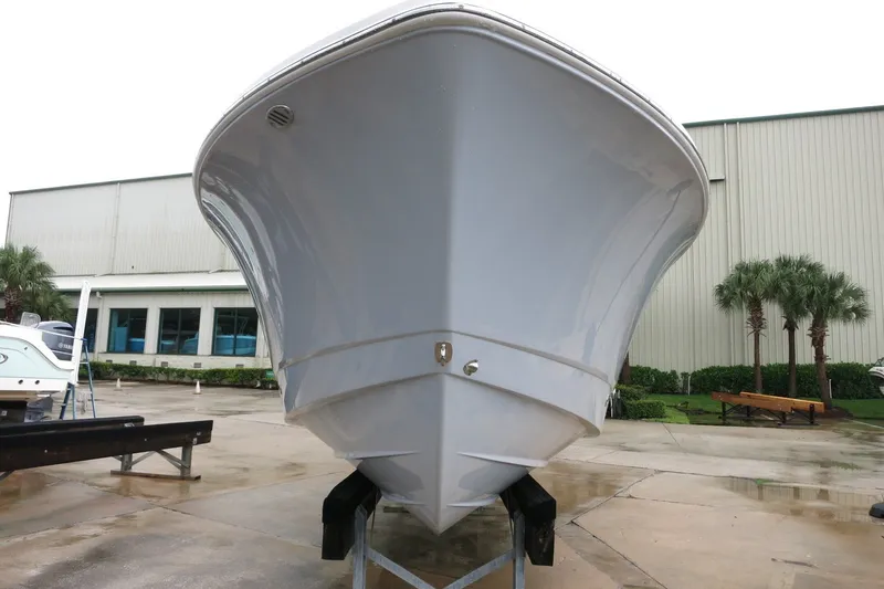 Slide: The Image of 2022 Robalo R230 Center Console boat on display at a marina. - 5