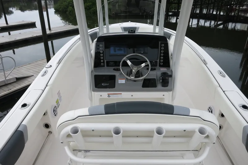 Slide: The Image of 2022 Robalo R230 Center Console boat interior with steering wheel and control panel. - 7