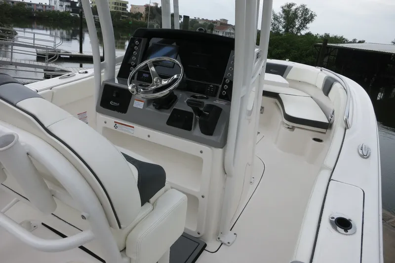 Slide: The Image of 2022 Robalo R230 Center Console boat interior with steering wheel and seating. - 12