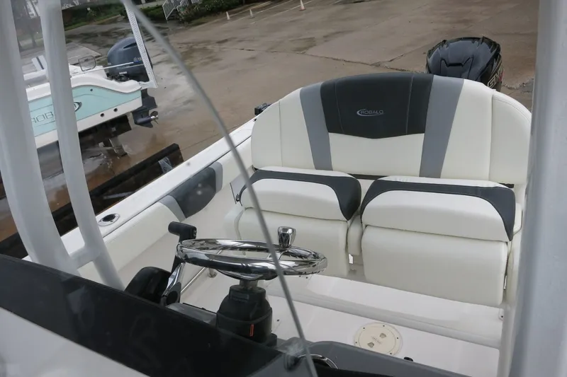 Slide: The Image of 2022 Robalo R230 Center Console boat interior with steering wheel and seating. - 21