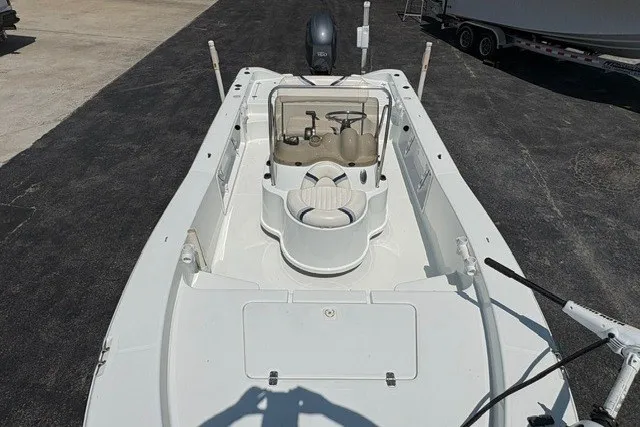 Slide: The Image of 2005 Polar 2100 Center Console boat, white interior, docked on asphalt surface. - 15
