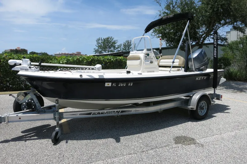 Slide: The Image of 2016 Key West 1720 Center Console boat on trailer, parked outdoors. - 14