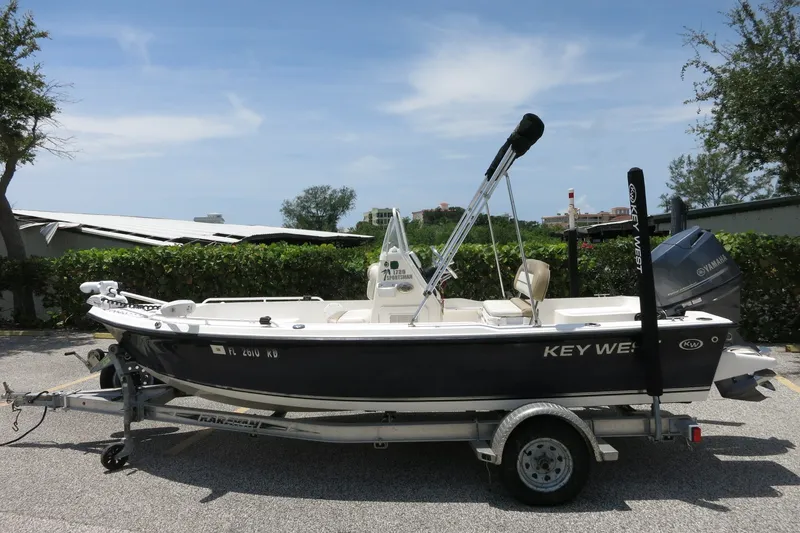 Slide: The Image of 2016 Key West 1720 Center Console boat on trailer, parked outdoors. - 15