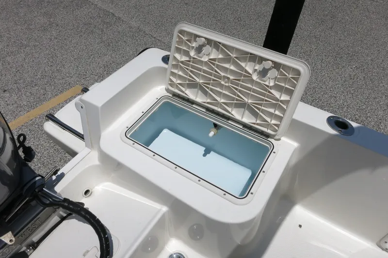 Slide: The Image of Open storage compartment on 2016 Key West 1720 Center Console boat. - 21