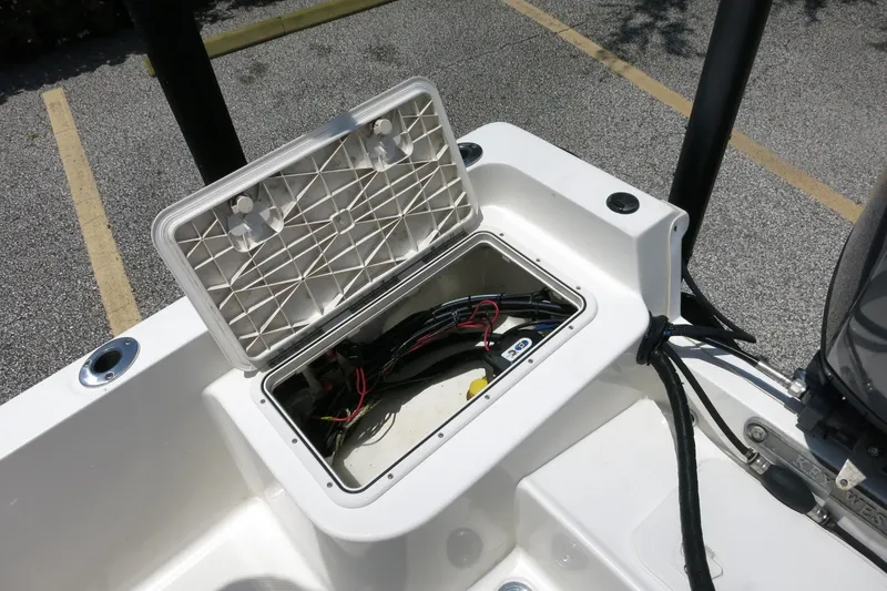 Slide: The Image of Open hatch on 2016 Key West 1720 Center Console boat, revealing wiring and components. - 20