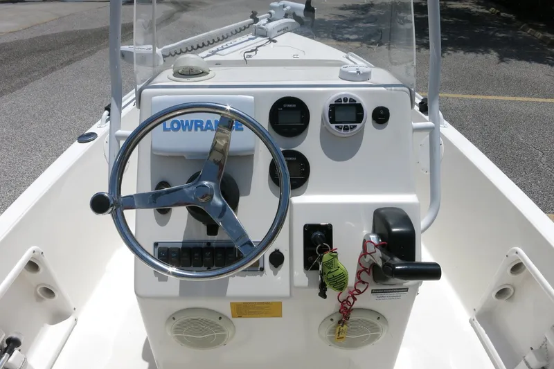 Slide: The Image of 2016 Key West 1720 Center Console boat dashboard with steering wheel and controls. - 25