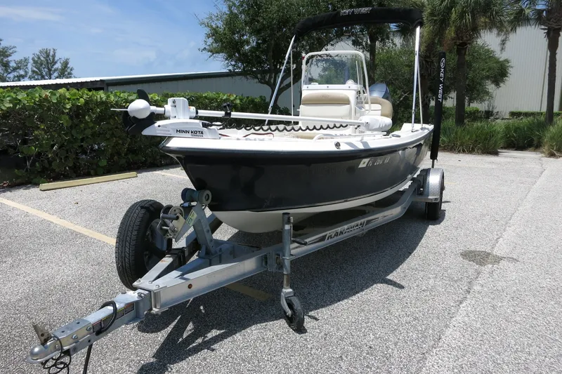 Slide: The Image of 2016 Key West 1720 Center Console boat on trailer in sunny parking lot. - 13