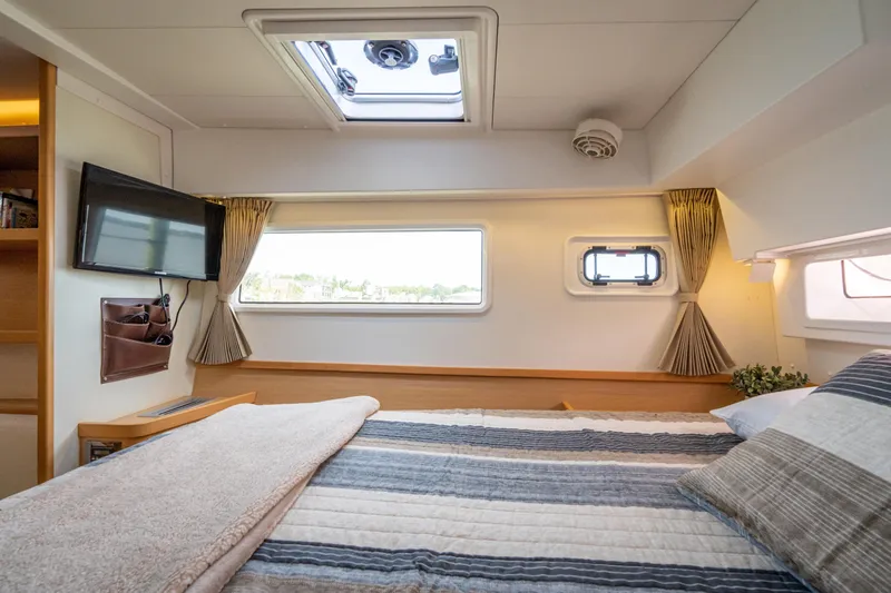Slide: The Image of The cabin of a 2017 Lagoon 42 with a cozy bed and a skylight. - 34