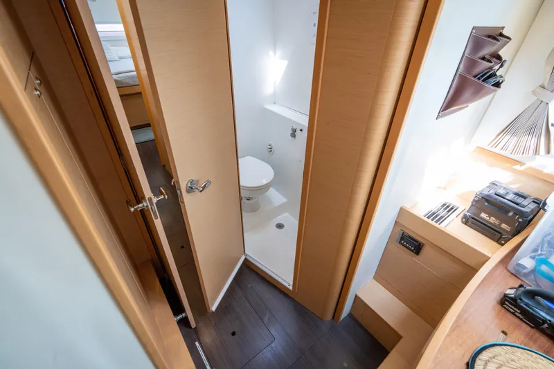 Slide: The Image of Interior of a 2017 Lagoon 42 featuring a bathroom and wooden flooring. - 48