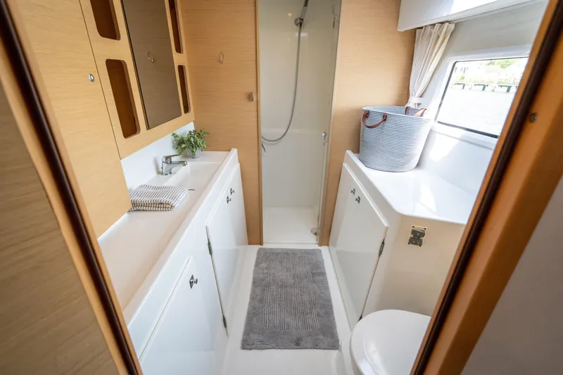 Slide: The Image of Interior view of a modern boat cabin with shower, sink, and storage. - 37