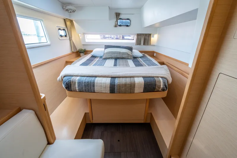 Slide: The Image of The image shows a cozy cabin with a double bed, wooden furnishings, and windows. - 32