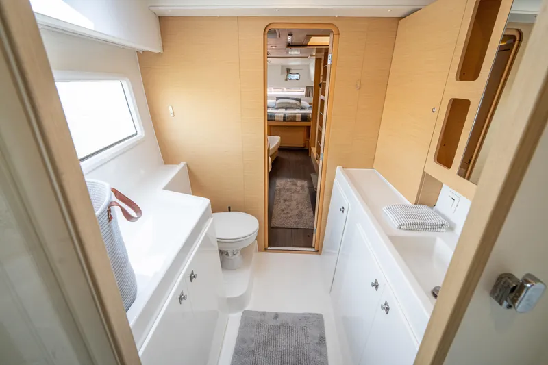 Slide: The Image of Interior view of a modern boat cabin with bathroom, sink, and wooden accents. - 39
