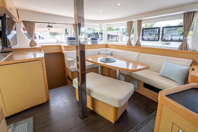 Slide: The Image of Interior of a 2017 Lagoon 42 with light upholstery and large windows. - 16