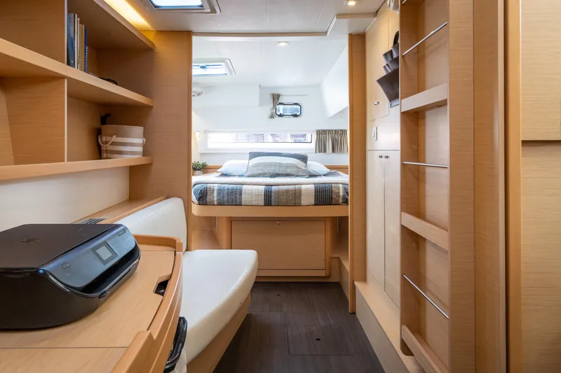 Slide: The Image of Interior of a 2017 Lagoon 42 featuring a cozy bedroom and wooden furnishings. - 30
