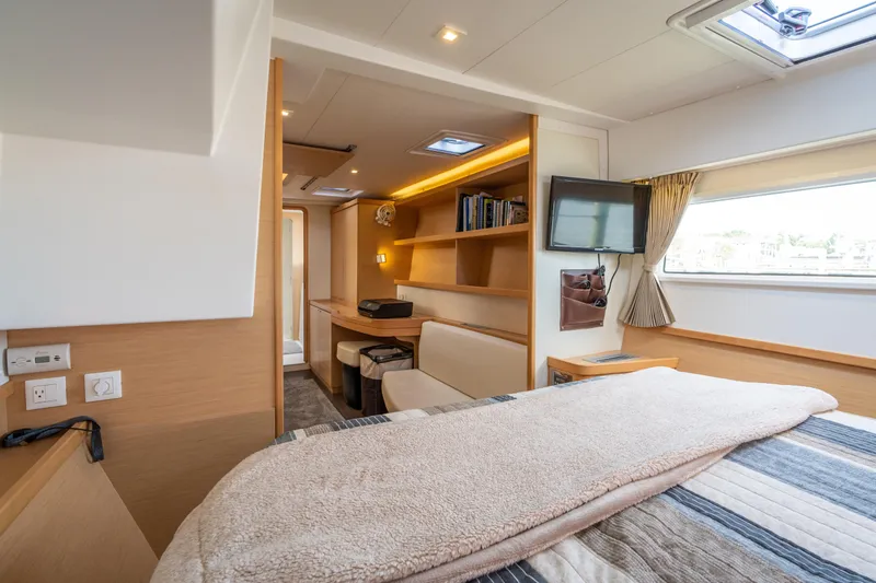 Slide: The Image of The image shows a cozy cabin with a bed, TV, and shelves. Light wood accents dominate the interior. - 33
